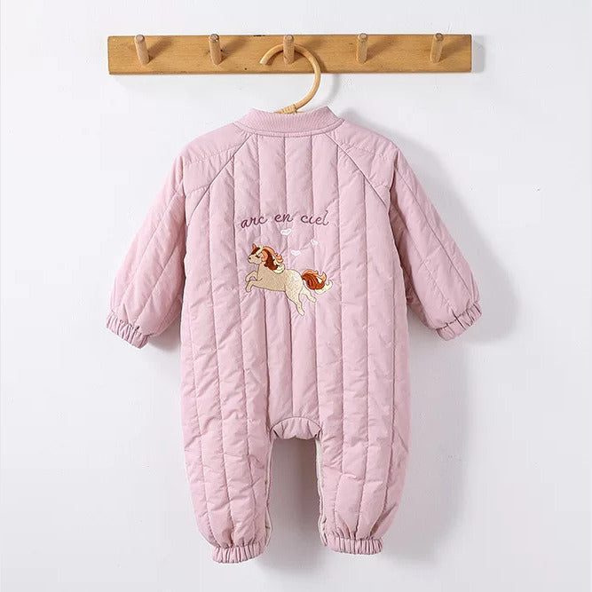 Back of a pink quilted baby romper with unicorn embroidery