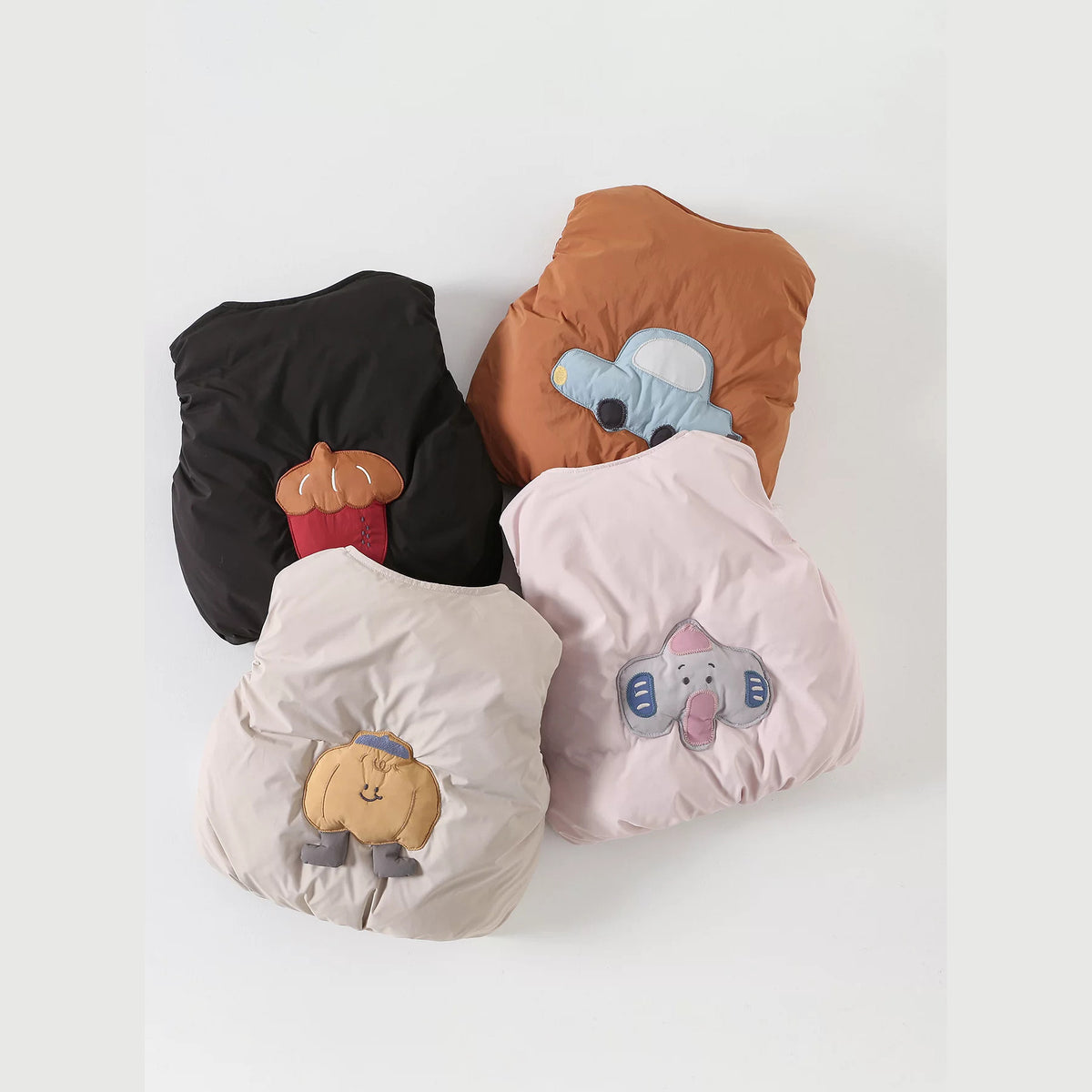 Five baby down vests with cartoon appliqués in black, rust, sage, blush and cream