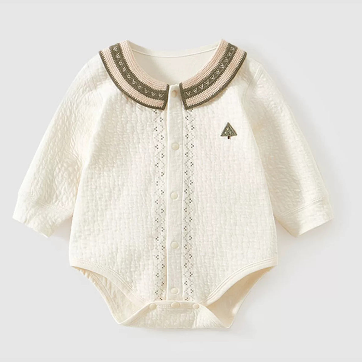 Cream baby onesie with folk-trim collar and openwork placket, flat lay