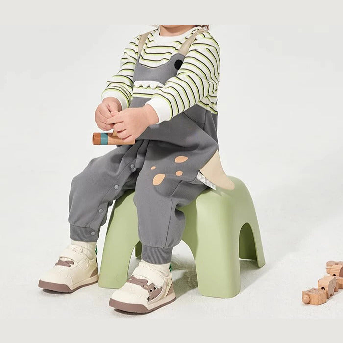 Side view of the grey baby romper showing snap legs and the tail detail