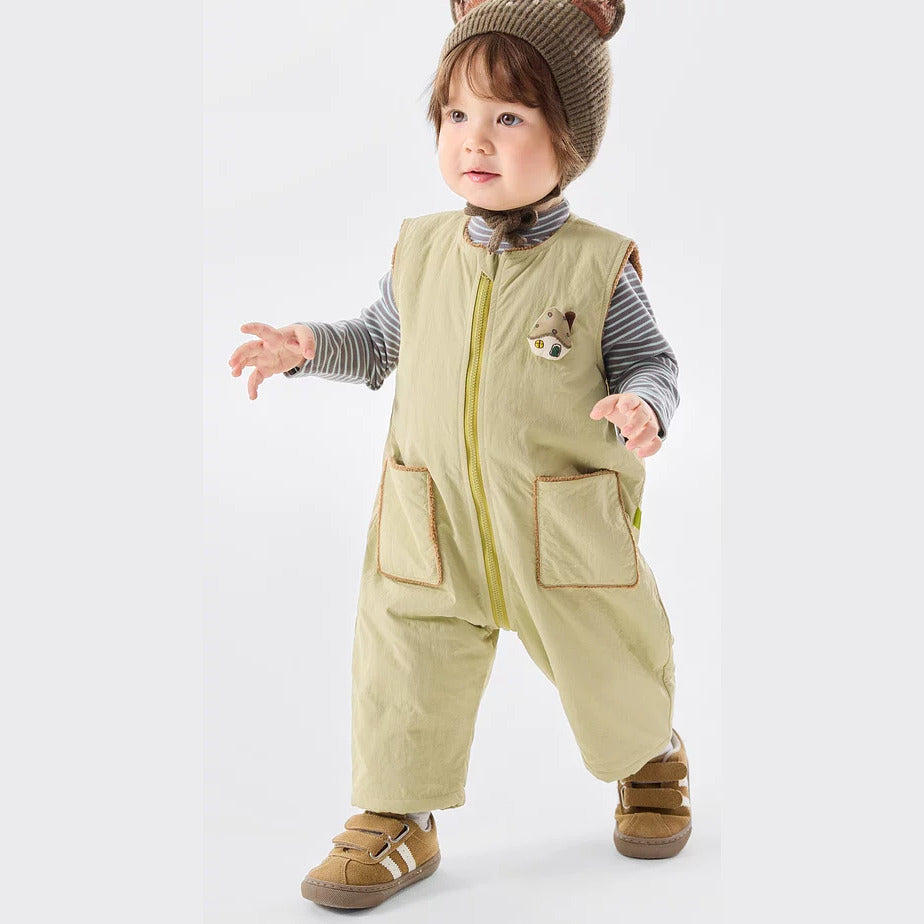 Toddler wearing the sage sherpa-lined romper over a striped top