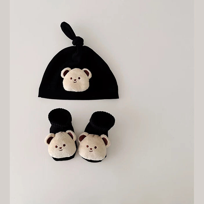 Black knot baby beanie and socks with soft cream bear faces, flat lay