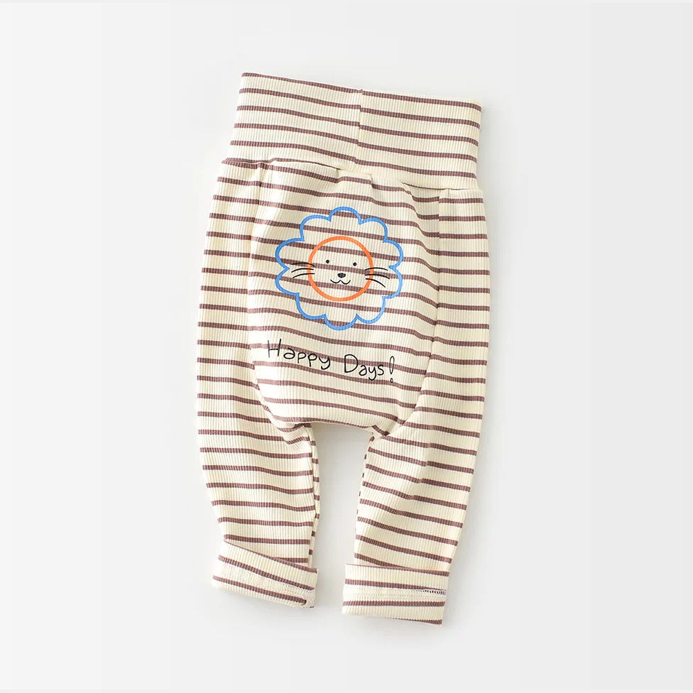 Brown and cream striped baby pants with a lion print, flat lay