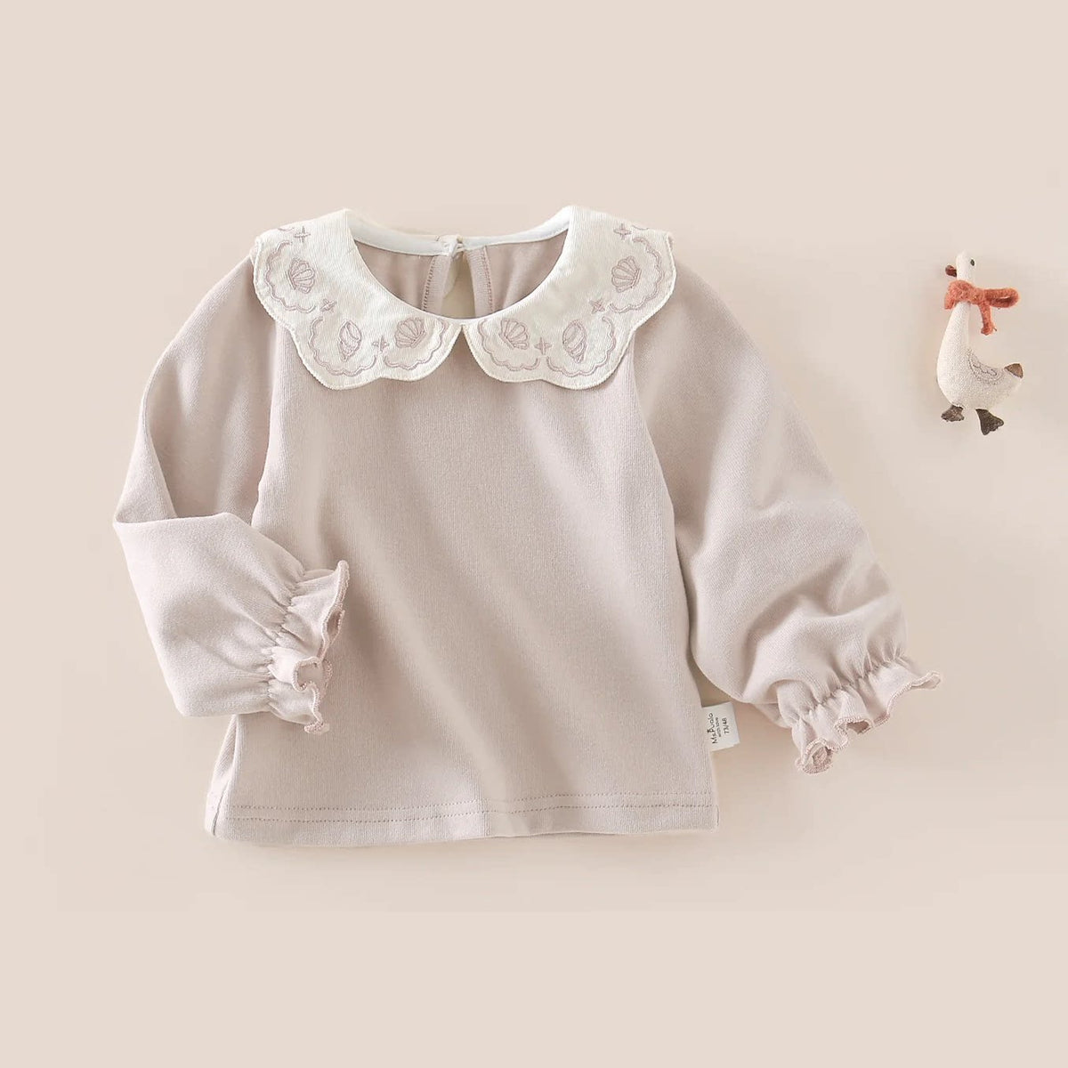 Long-sleeve girls top with embroidered shell collar and ruffle cuffs