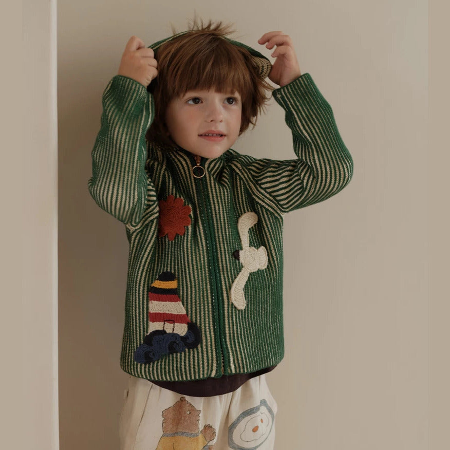 Child playing in a green striped knit zip cardigan