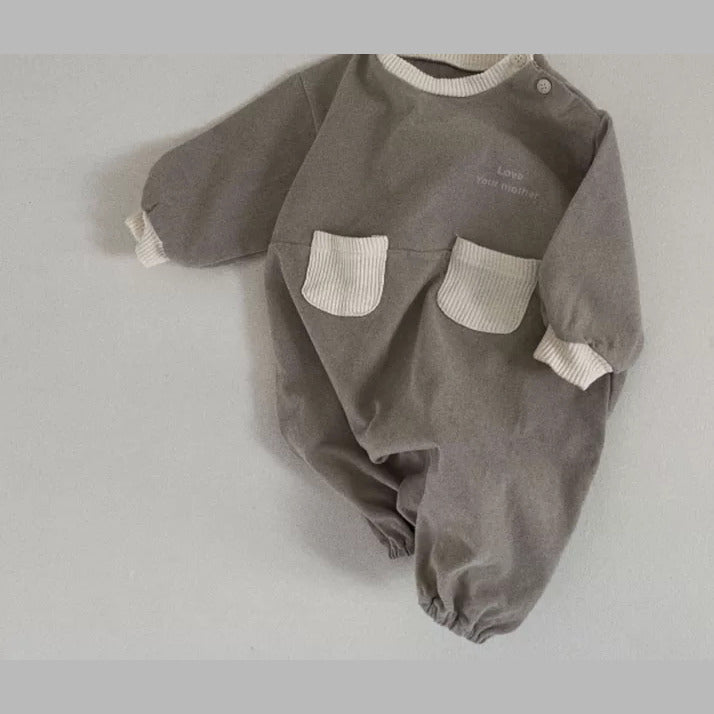 Stone grey baby romper with contrast pockets and balloon legs