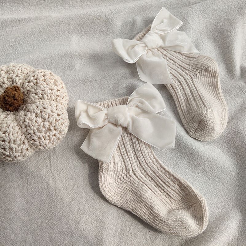 White ribbed baby socks with velvet bows
