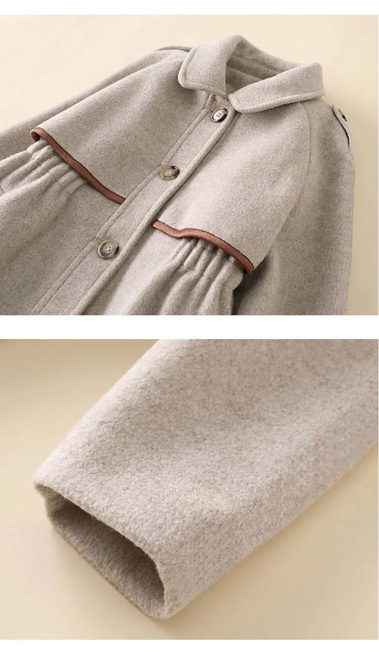 Close-up of collar and sleeve of oatmeal wool coat