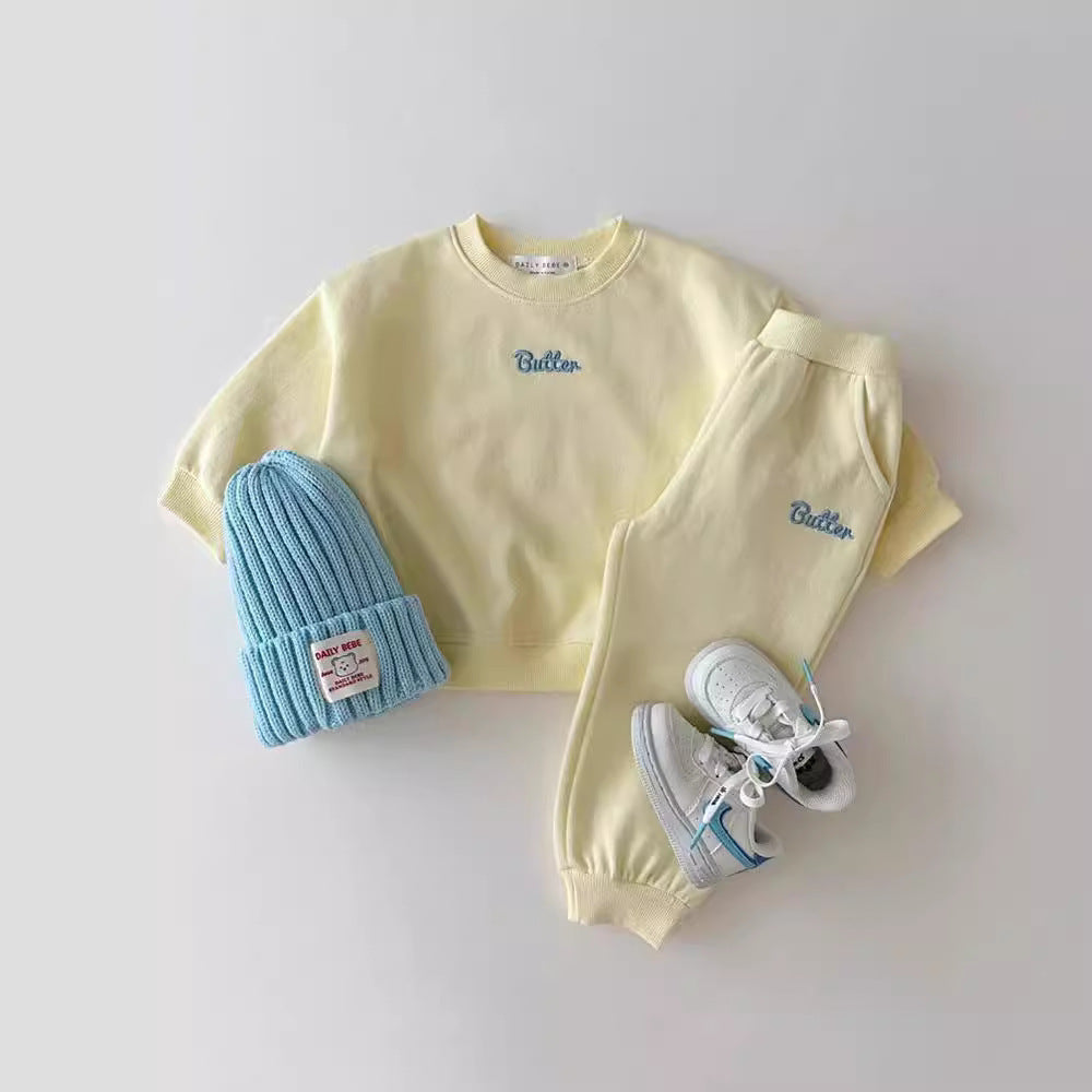 Pale yellow sweatshirt and joggers set with blue beanie