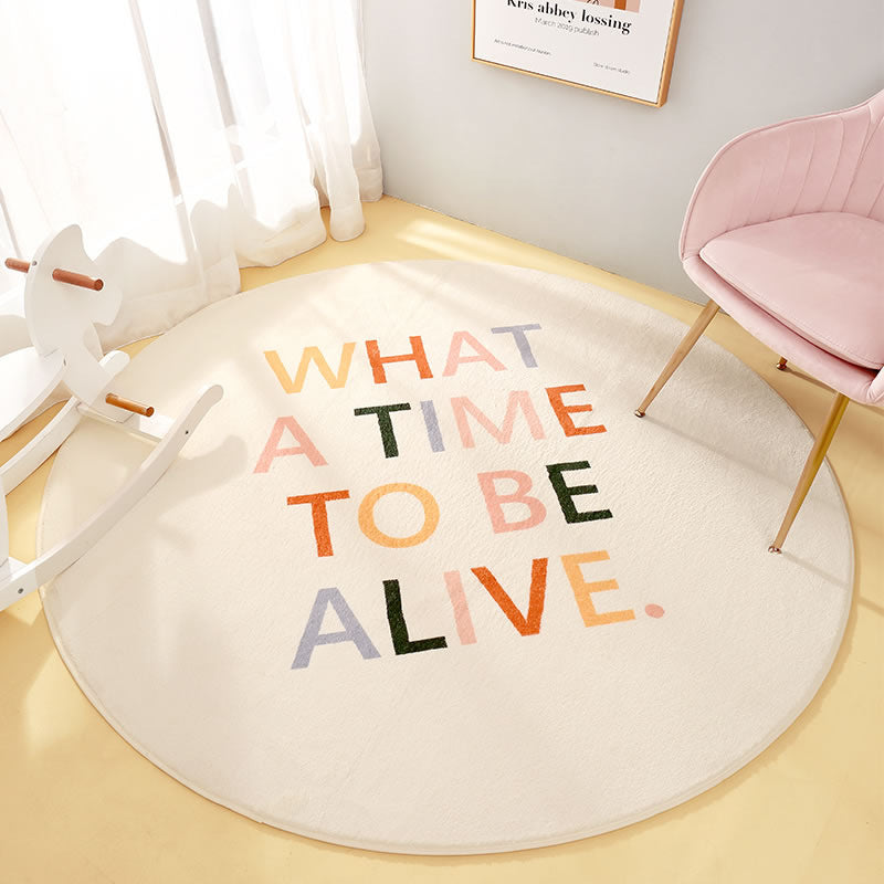 Round nursery carpet with "What a time to be alive" colorful quote lettering