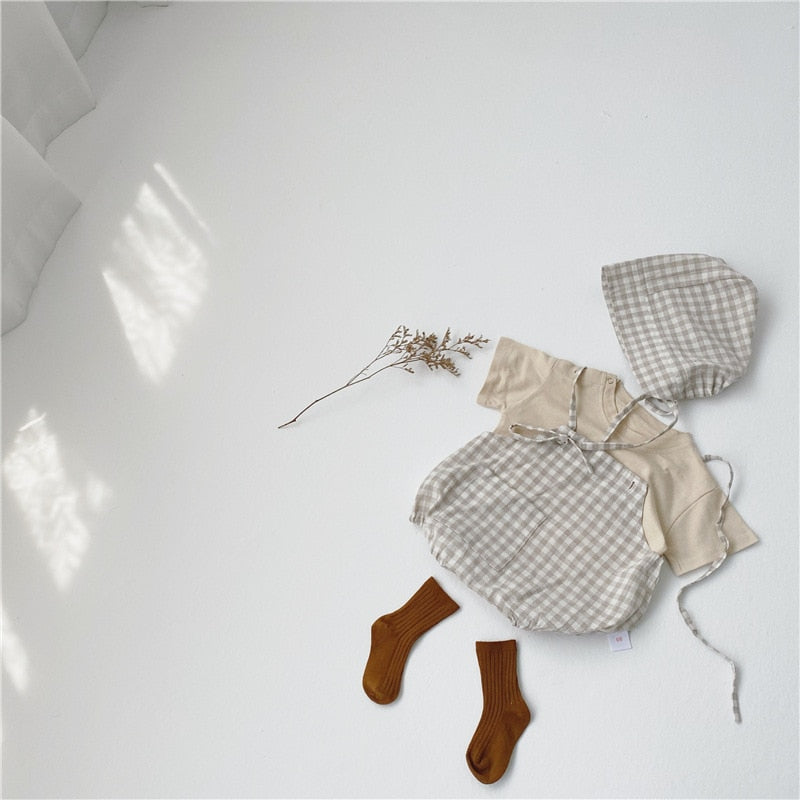  This bodysuit features a timeless plaid pattern that adds a touch of sophistication to their ensemble. 