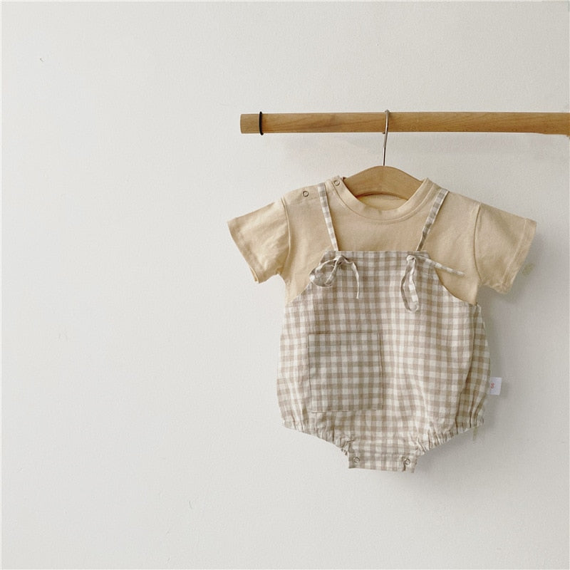  This bodysuit features a timeless plaid pattern that adds a touch of sophistication to their ensemble. 