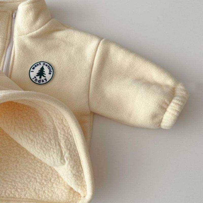 Close-up of polar fleece texture and badge patch on the sleeve