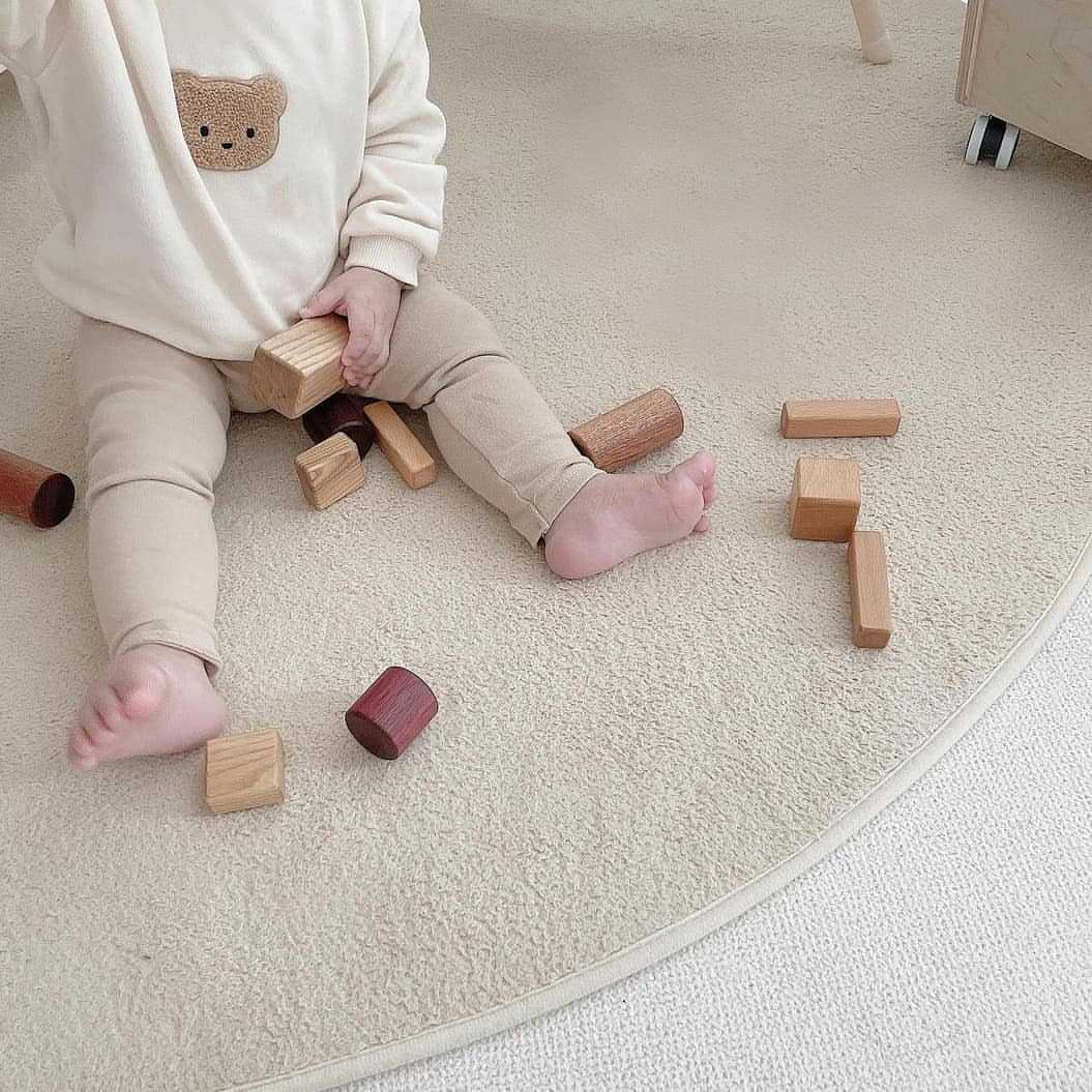 Baby playing in white bear sweatshirt