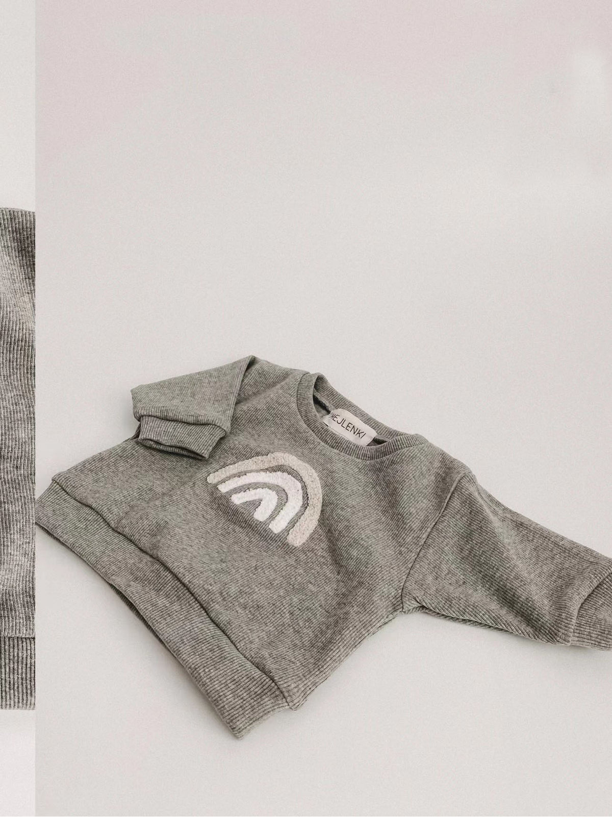 Grey rainbow sweatshirt for babies, side view