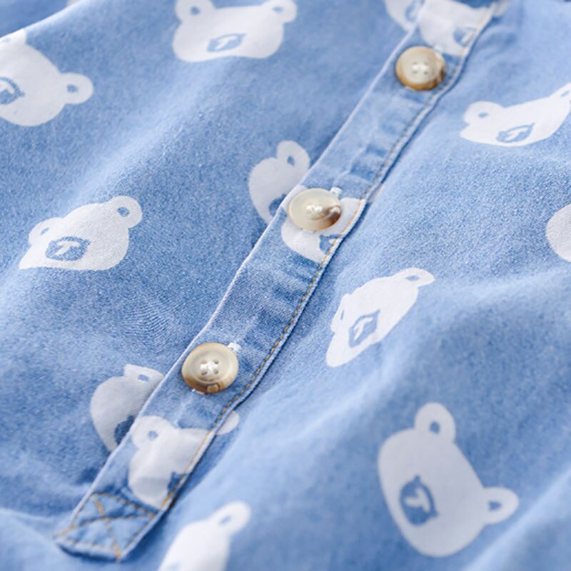 Close-up of buttons on bear print denim