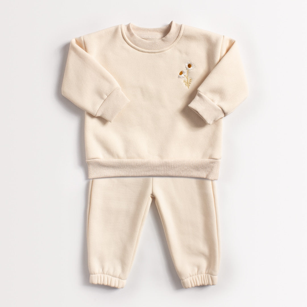 Beige daisy sweatshirt and joggers on white background