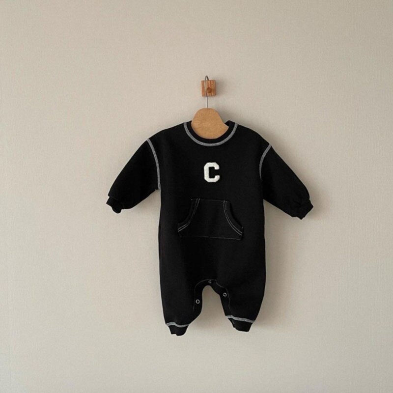 Black C letter jumpsuit on a hanger