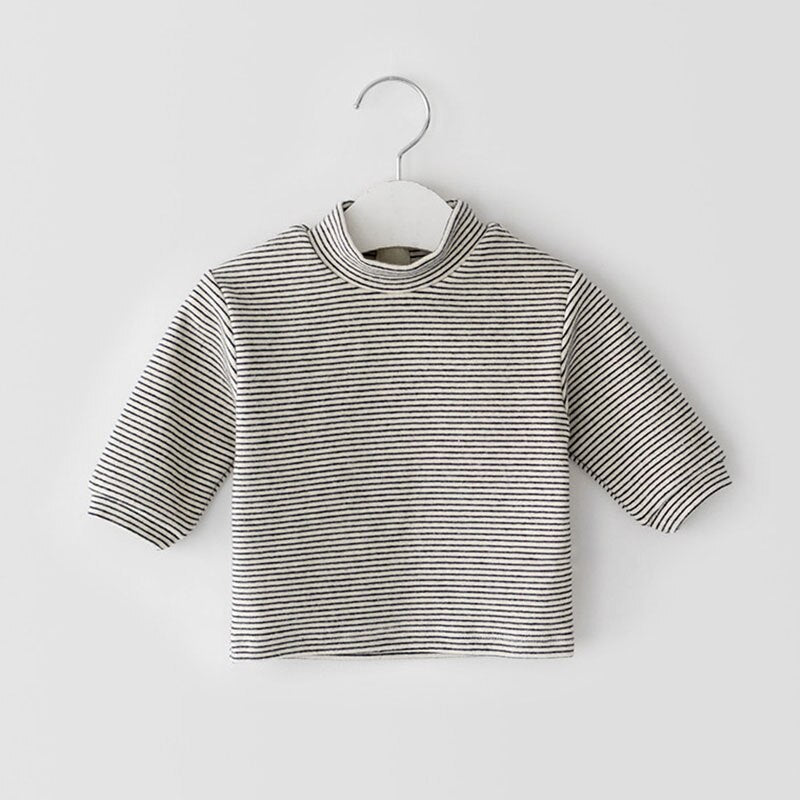 Black and white striped mock neck top on a hanger