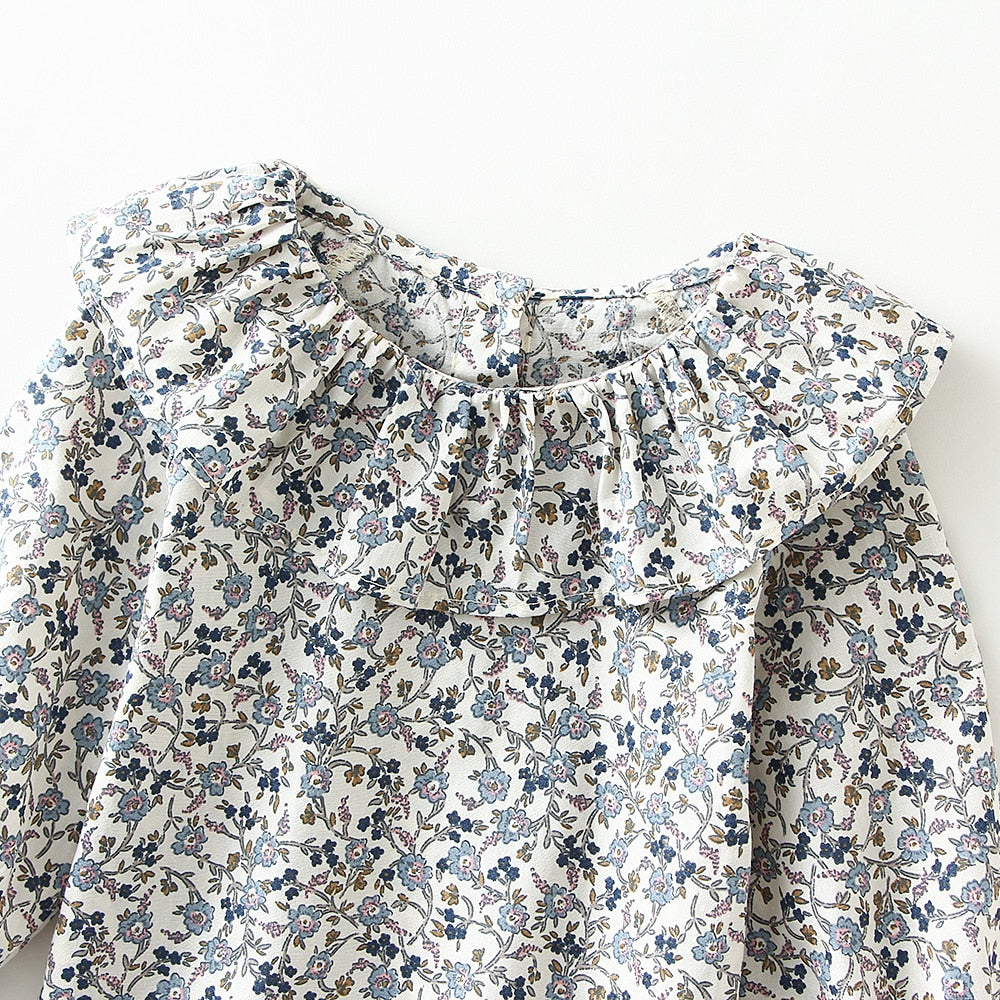 Close-up of blue floral ruffle collar
