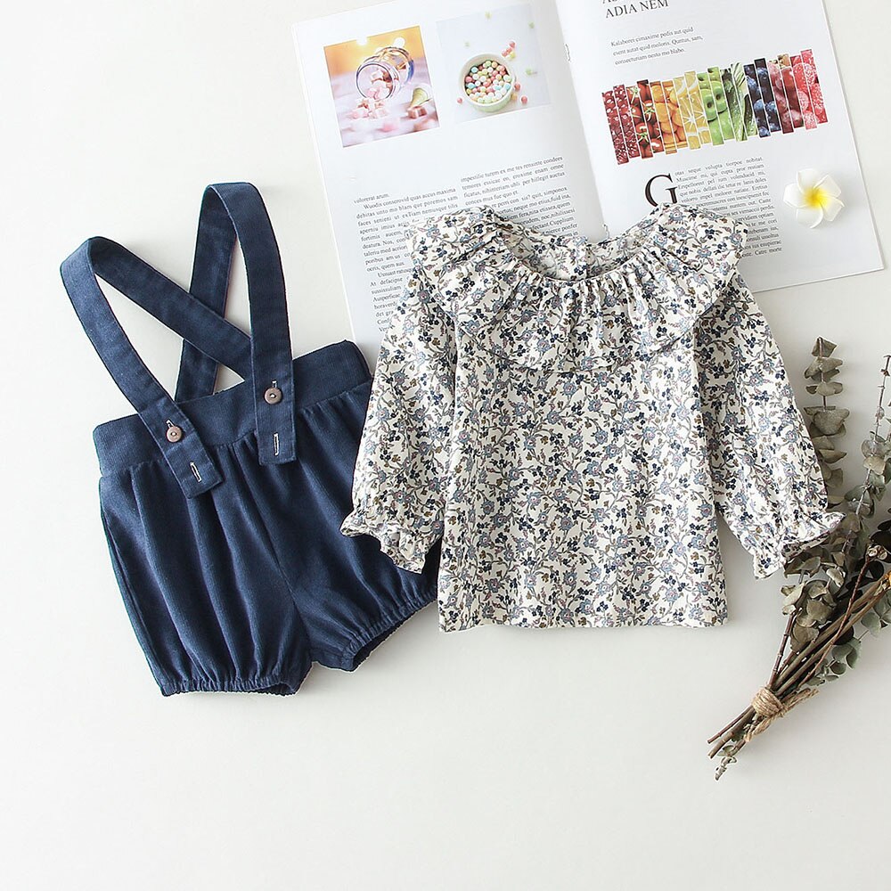 Blue floral shirt styled with denim overalls