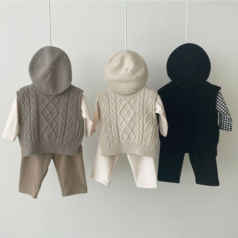 Gray, beige and black cable knit vests styled with hats