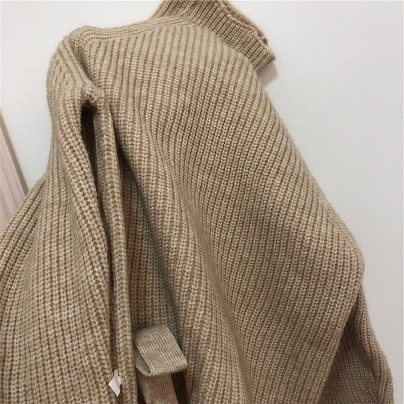 Close-up of side slit on camel knit sweater