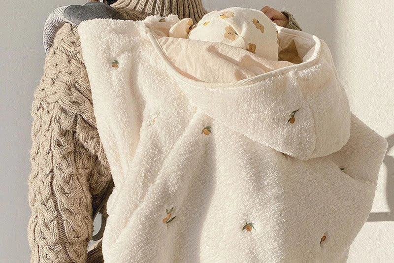 Plush cape held over a shoulder