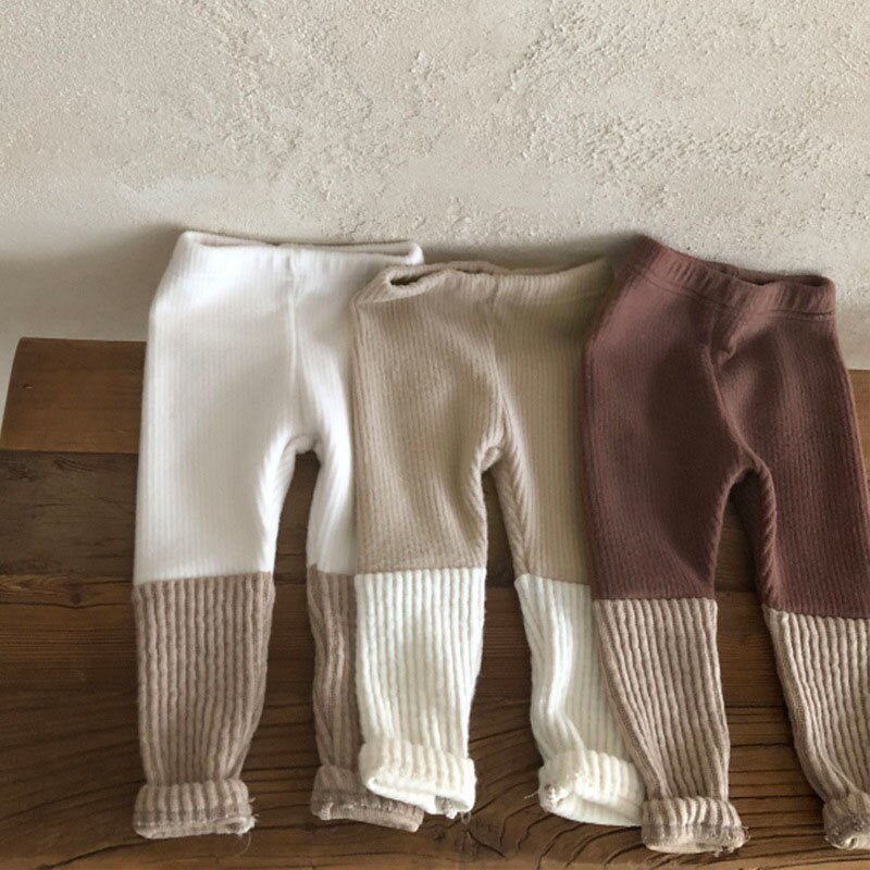 Three colour block leggings laid flat