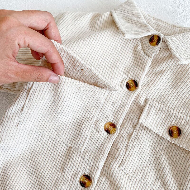 Close-up of pocket and buttons on corduroy jumpsuit