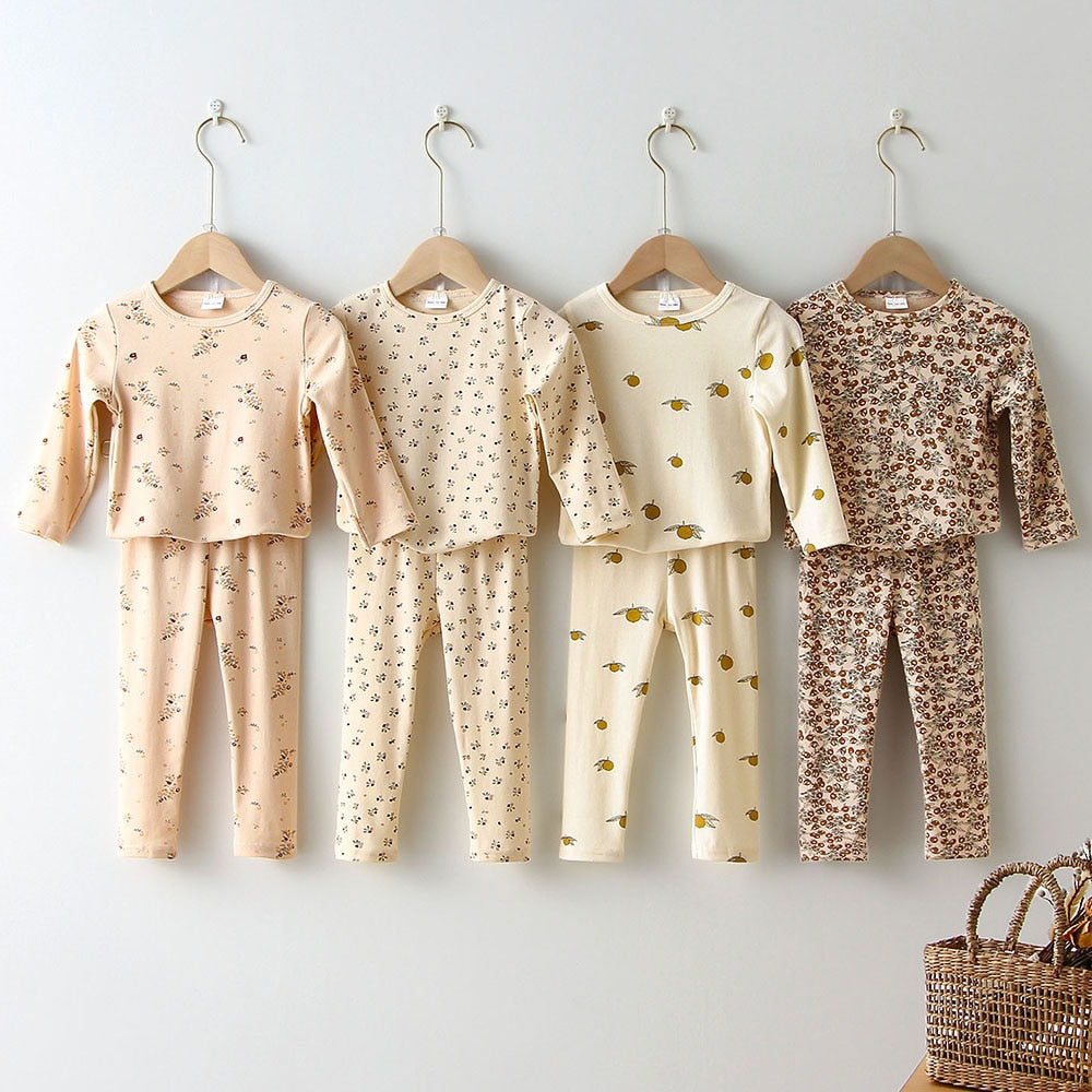 Four cotton print pajama sets hanging on a wall