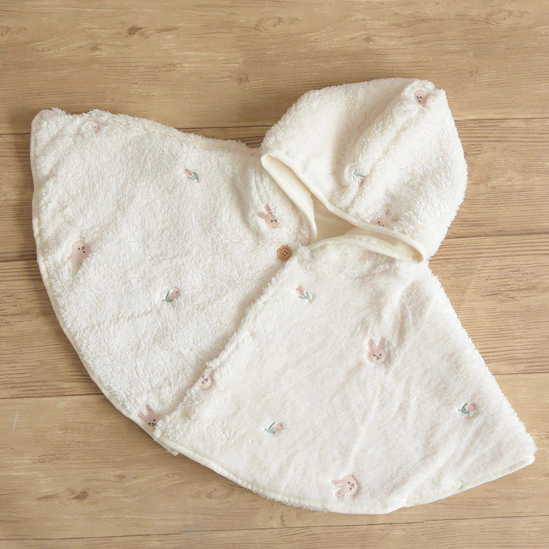 Cream plush hooded baby cape laid flat