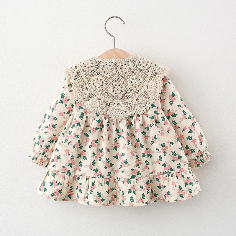 Back view of floral dress with crochet shawl
