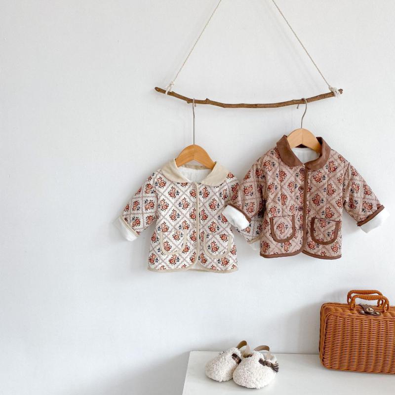 Floral quilted jackets hanging on a branch