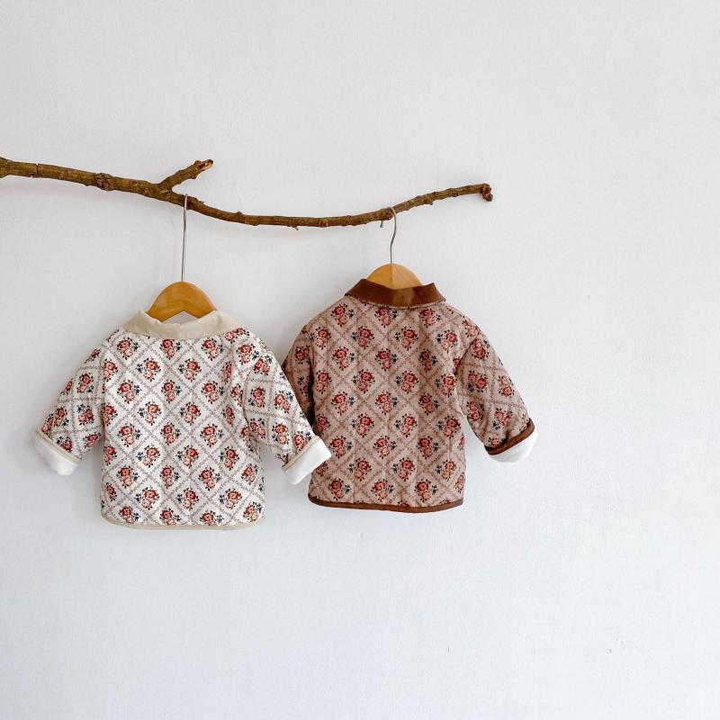 Pair of floral quilted jackets hanging