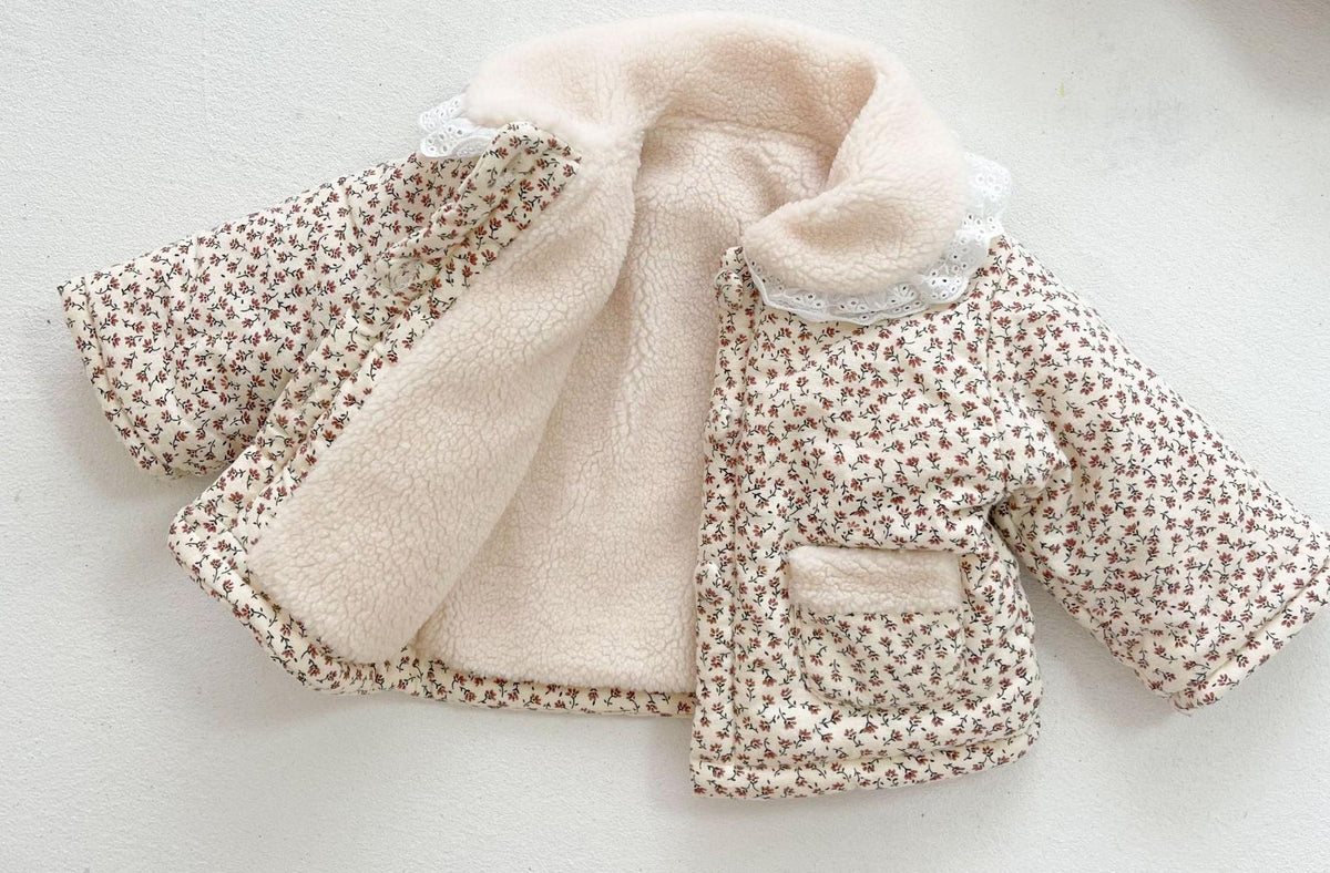 Floral quilted baby girl jacket with lace collar on white background