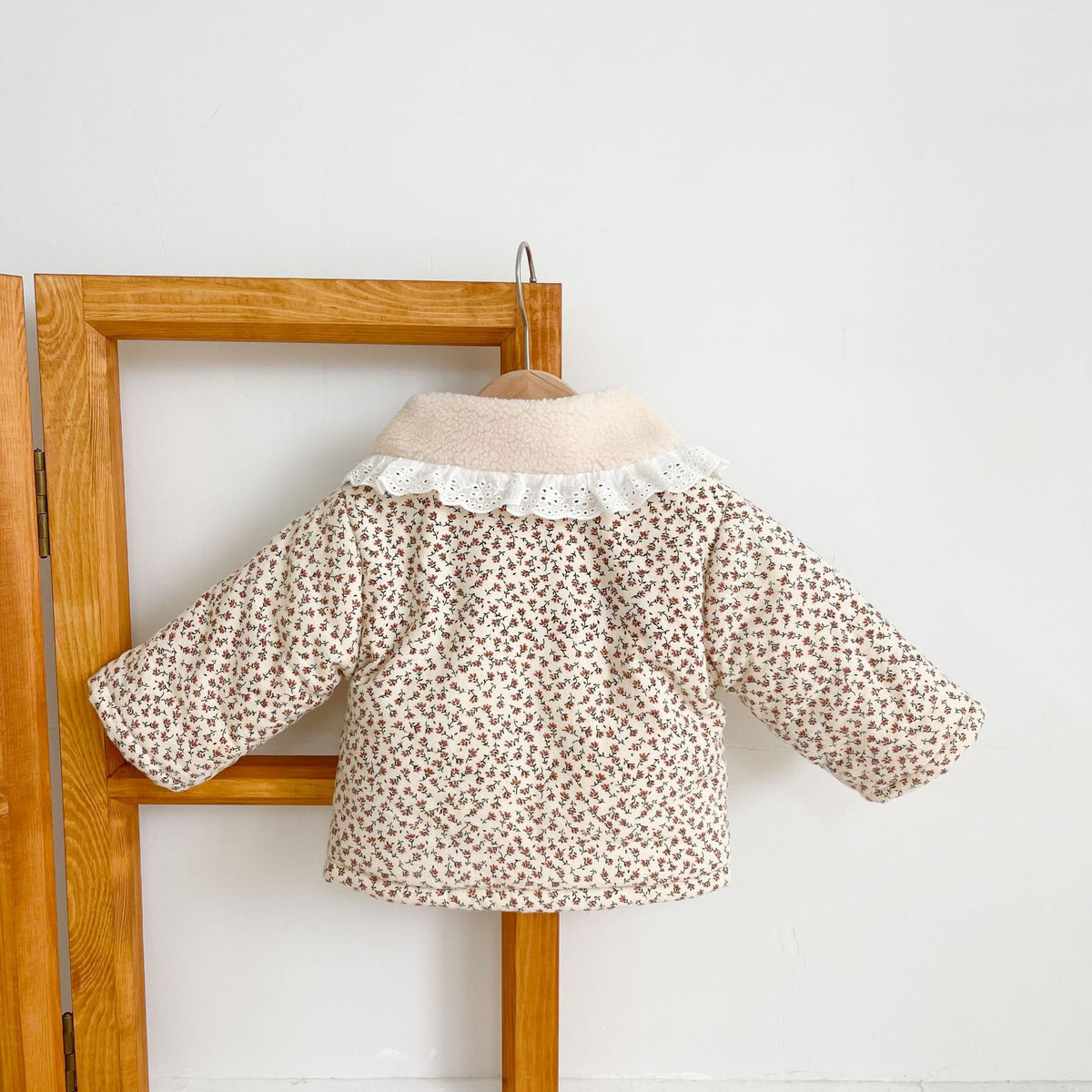 Sherpa lining inside the floral quilted baby jacket