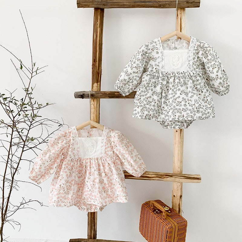 Pink and grey floral retro dresses on a ladder