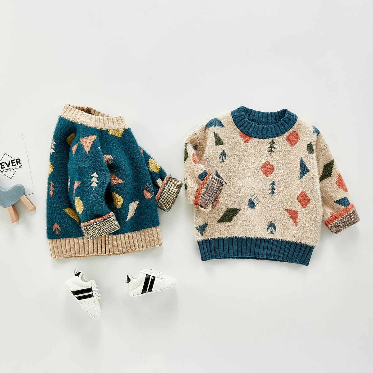 Geometric sweaters laid flat with socks