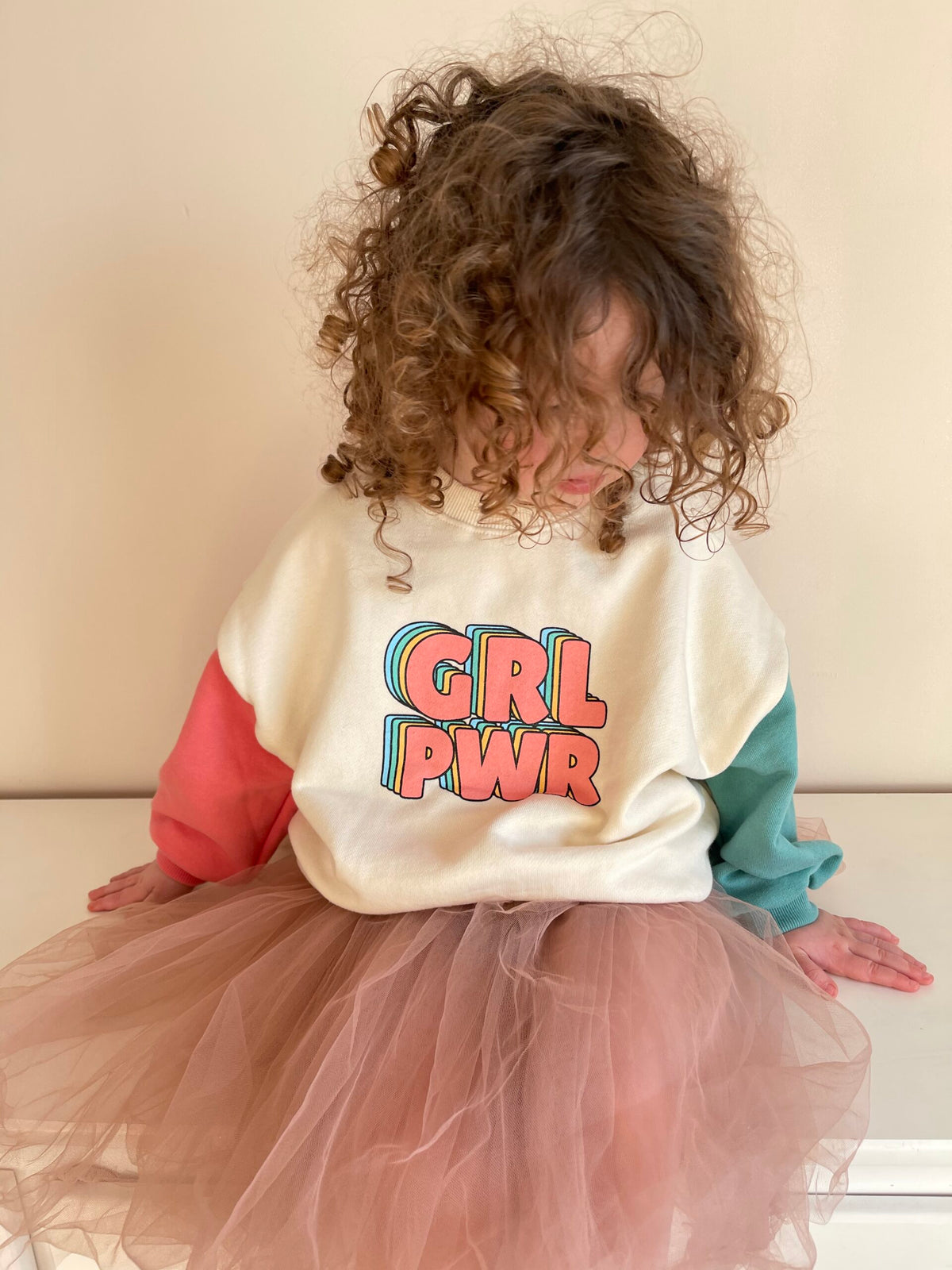 Girl in GRL PWR top with pink tulle skirt