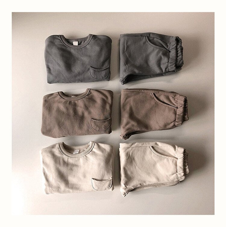 Gray, brown and cream sweatshirt sets laid flat
