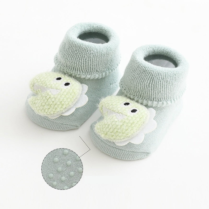 Green thick baby socks with dinosaur toppers