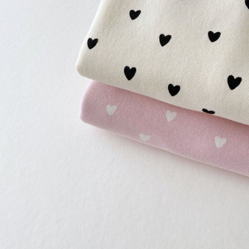 Close-up of beige and pink heart print fabric