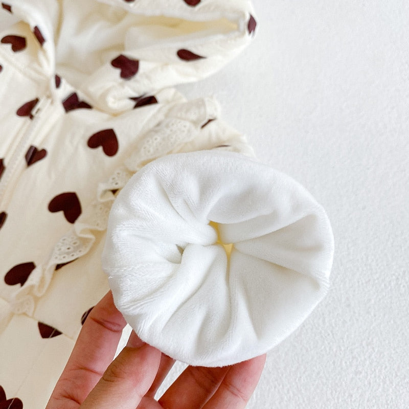 Close-up of fleece-lined cuff on heart romper