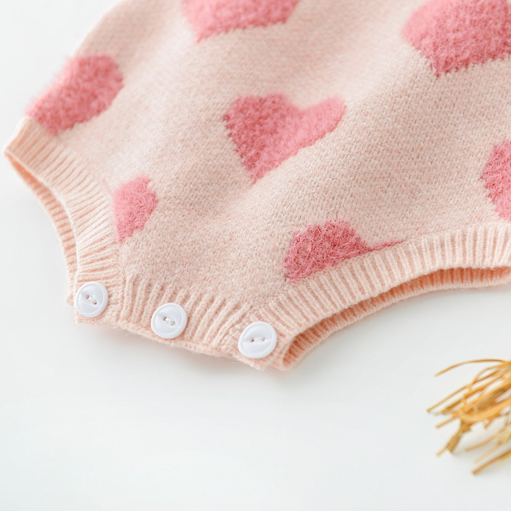 Close-up of snaps on pink heart romper