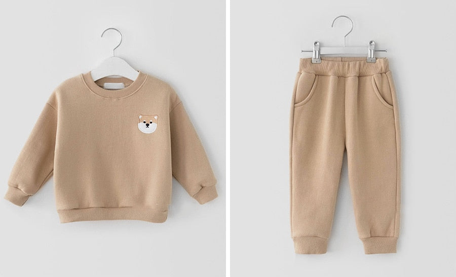 Khaki sweatshirt and joggers on hangers