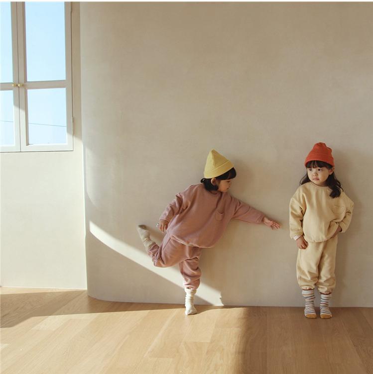 Kids in pink and yellow sets playing