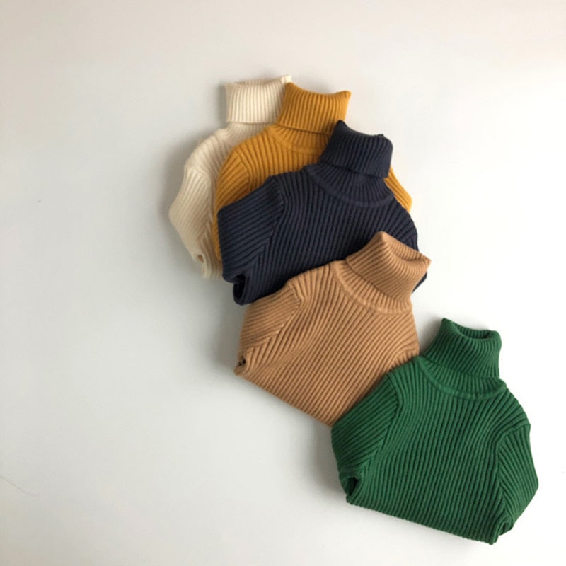 Stack of kids rib knit turtleneck sweaters