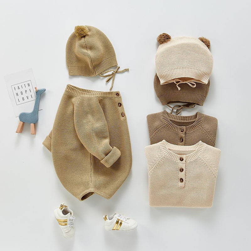 Knit bodysuit and bear ears hat laid flat