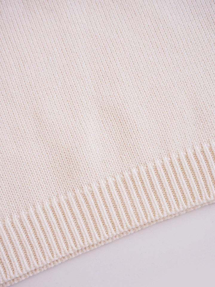 Close-up of ribbed hem on beige pullover